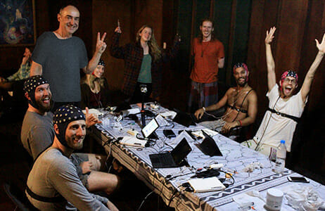 Study participants gathered around a table wearing monitors