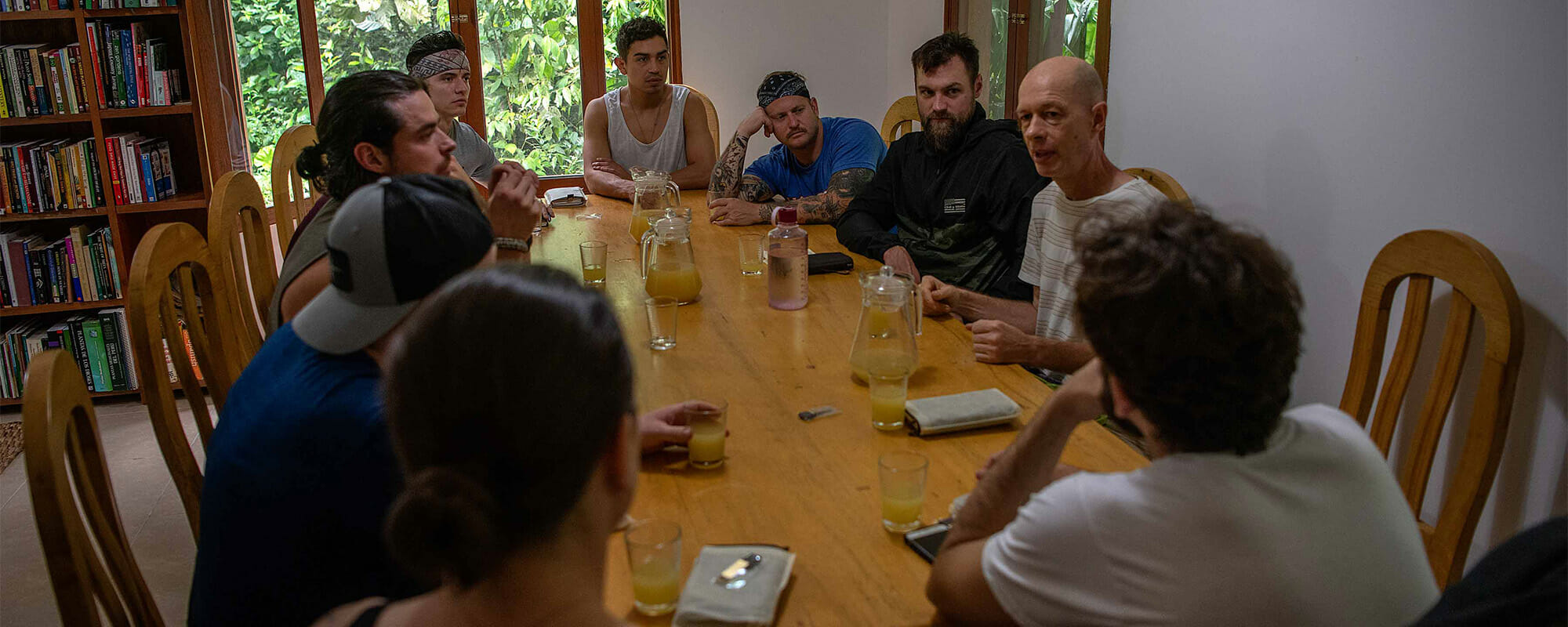 Group of people gathered around a table talking