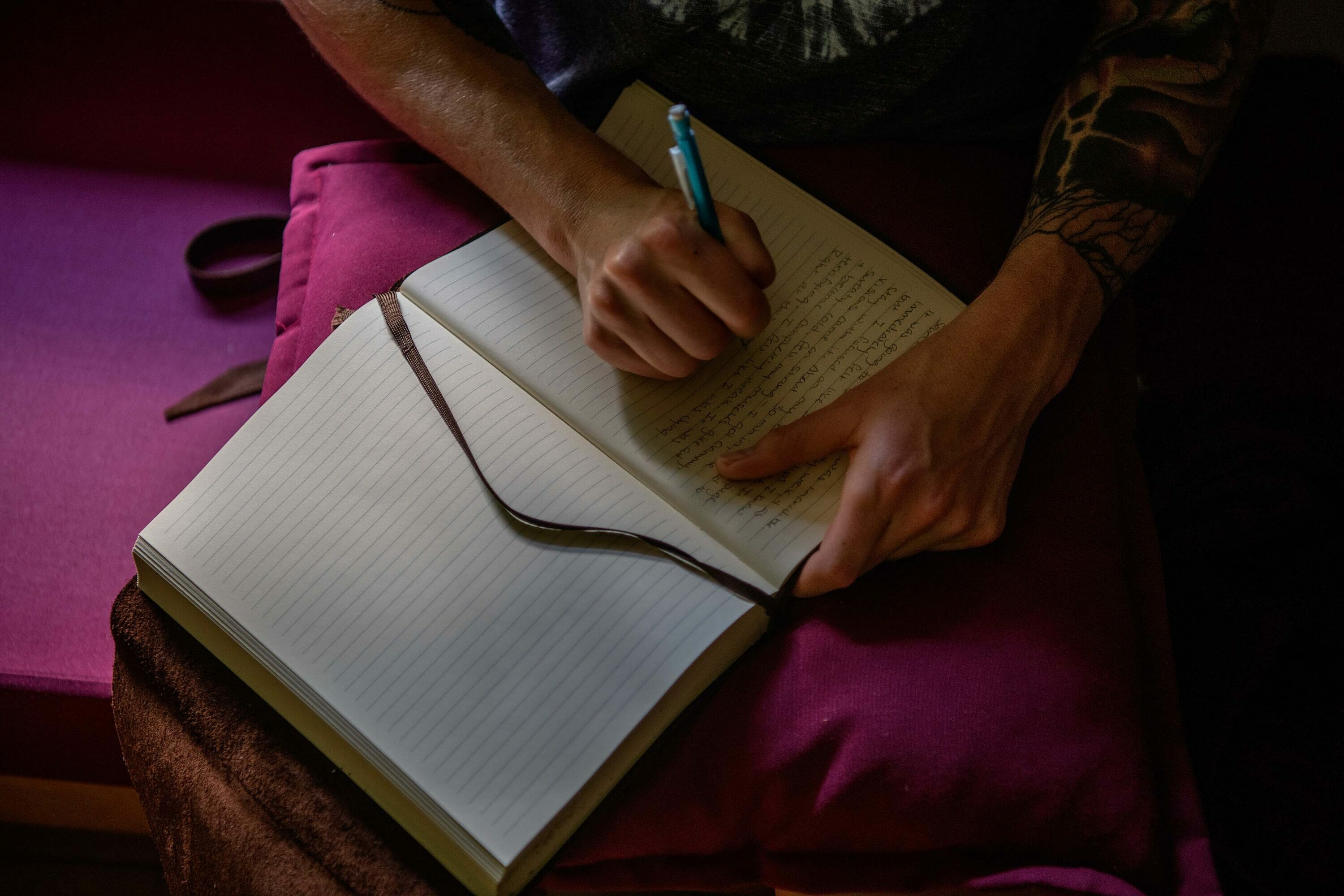 Hands of a person writing in a journal