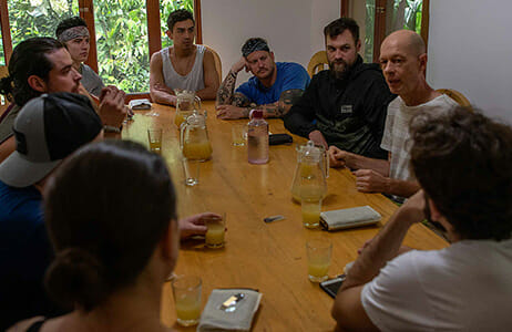 Group of people sitting around a table and talking