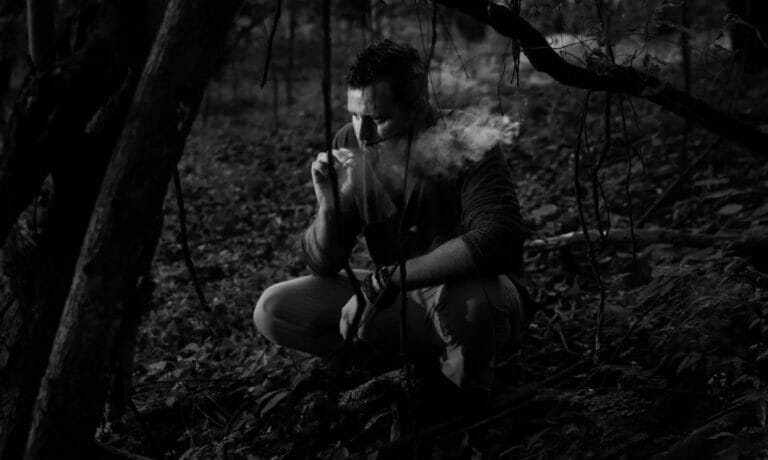 Photo of person smoking in the jungle